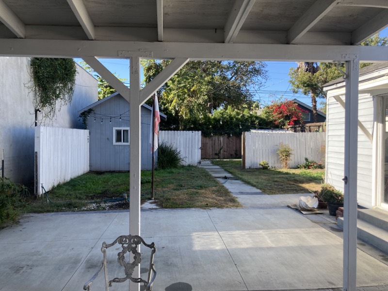 Looking out from under the patio cover across the empty back yard before planting began.